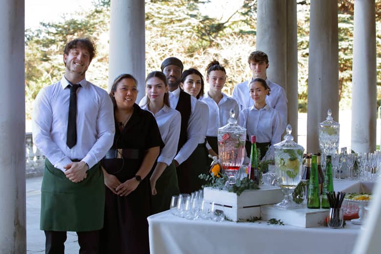 PenniBlack staff smiling at an event.